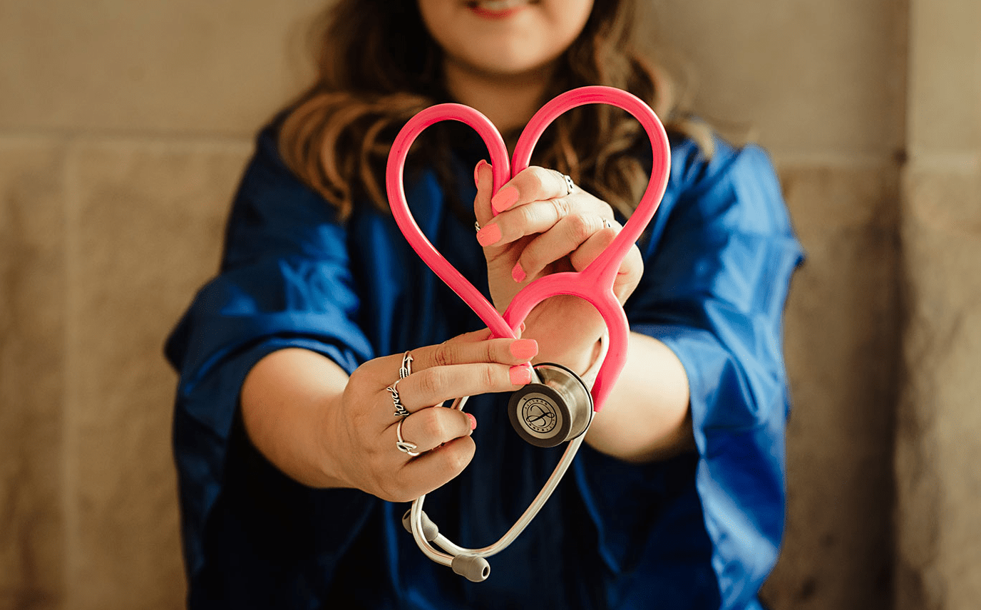 Medical student Medical student holding stethoscope in a heart shape.